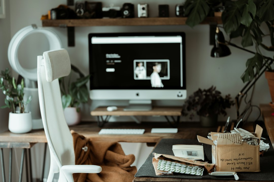 Pictime website open on an iMac at a home office space